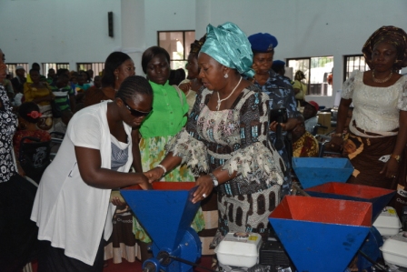 A blind woman receiving grinding machine from the wife of Abia state governor, Lady Mercy Odochi Orji at the event