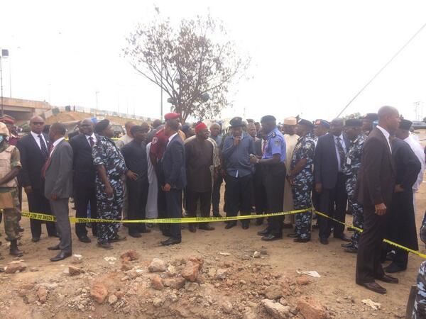 PRESIDENT JONATHAN & HIS ENTOURAGE BEING BRIEFED AT THE SITE OF THE CRATER LEFT BEHIND BY THE EXPLOSION IN NYANYA ON MONDAY 