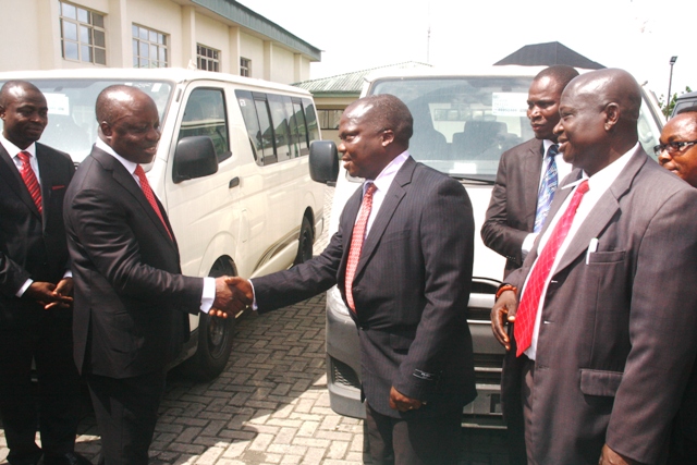 Governor Emmanuel Uduaghan of Delta State 2nd left flanked by his Special Adviser on Legal maters Barr. Andrew Oduh behind the Governor in handshake with Chairmen of NBA Branches during the handover of Buses to the various b