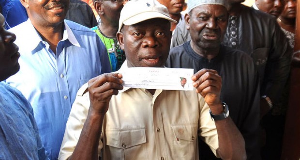 EDO STATE GOVERNOR ADAMS OSHIOMHOLE DISPLAYING HIS ALL PROGRESSIVES CONGRESS (APC) MEMBERSHIP CARD AFTER REGISTERING AT IYAMHO, ETSAKO WEST LOCAL GOVERNMENT AREA.