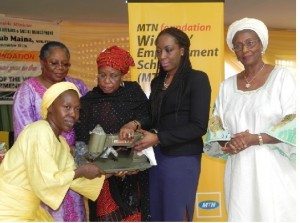 Minister of Women Affairs, handing over a Sewing Machine to one of the beneficiaries of the Widowhood Empowerment Scheme, and assisted by the Exec Sec, MTN Foundation, Nonny Ugboma,  DG National Centre for Women Development, Lady Onyeka Nwenu and a Director of MTNF.