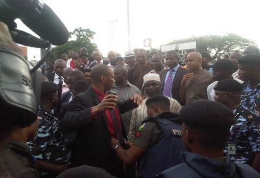 EDO HOUSE OF ASSEMBLY SPEAKER, UYI IGBE, BEING FRISKED BEFORE ENTRY INTO THE COMPLEX