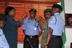 FRANK MBA BEING DECORATED WITH NEW RANK BY IGP MD ABUBAKAR, DEPUTY DIRECTOR (INFORMATION) SSS, MARILYN OGAR & DEFENCE SPOKESMAN, MAJ-GEN. CHRIS OLUKOLADE