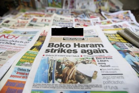 A newspaper with its headline on an abduction of women is displayed in Lagos