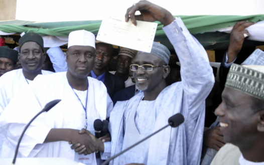 2015: Northern Youth Forum Contribute N2m For Jonathan To Buy PDP Nomination Form 3 EDUCATION MINISTER, IBRAHIM SHEKARAU RAISING THE 2MILLION CHEQUE DONATED TOWARDS THE PRESIDENT’S RE-ELECTION BY THE YOUTH
