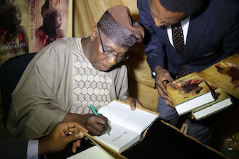 The Author, Olusegun Obasanjo authograph one the book at the event.