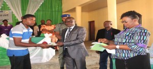 Ekiti State D.Gov., Dr. Kolapo Olusola (middle) presenting JAMB scratch card to one of the beneficiaries, Master Oluwadamilola Omolayo (left) at Olaoluwa Grammar School, Ado-Ekiti on Monday, with them is the Director (AANFE), Dr. Oladimeji.