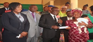 Governor Fayose extols President Goodluck Jonathan initiated (SURE-P) on Maternal Child Health (MCH) 3 Ekiti State D. Gov., Dr. Olusola (2nd right) giving cash to one of the beneficiaries of the SURE-PMCH Programme, Mrs. Olanipekun at the flag-off of the programme in Ado-Ekiti. With them are; the PS, D.Gov's Office, Mrs. Akindele, the PS, Ministry of Health, Dr. Olomojobi (2nd left) and her counterpart at the HMB, Dr. Aina.