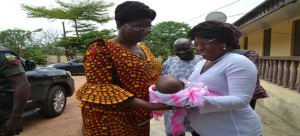 Wife of Ekiti Gov., Mrs. Fayose (left) receiving a baby from the Matron of Erelu Adebayo Children Home, Iyin-Ekiti, Mrs. Abiodun during the governor's wife visit to the Children Home.