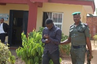 Egbeniyi Oluwafemi with security official