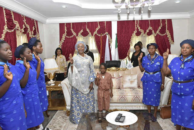 Her Excellency Mrs Toyin Saraki with Members of the Holy Rosary Girls College Girl Guides Area Council Gwagwalada Reciting the Girl Guides' Promise