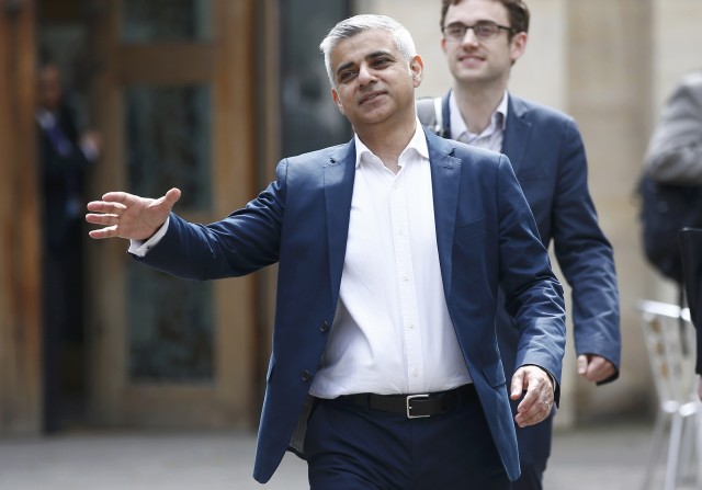 London's Mayor elect, Sadiq Khan, goes to shake hands with a passer-by as he leaves Southwark Cathedral in London, Britain, May 7, 2016. REUTERS/Peter Nicholls