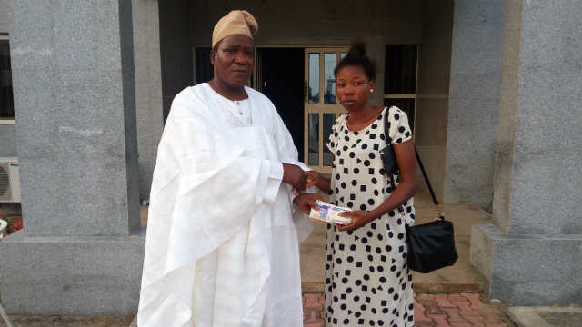 Otunba Niyi Osoba handling donation to Toluwalase Opeyemi