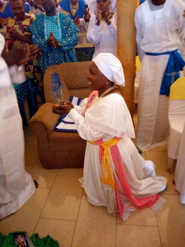 Mother Celestial Adenike Adebutu enthusiastically displays her plaque
