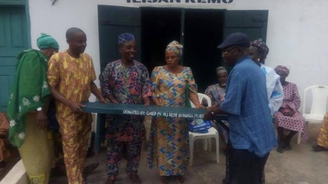 Ikenne LG PDP Ward 8 executives display one of the benches donated to the party secretariat by Hon Sonuga