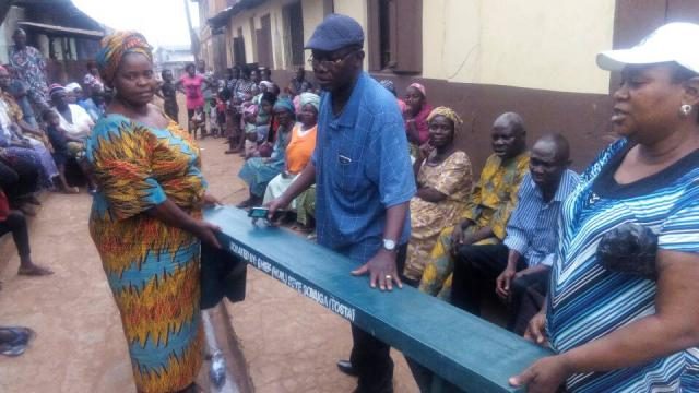 Ikenne LG PDP Ward 9 executives display one of the benches donated to the party secretariat by Hon Sonuga