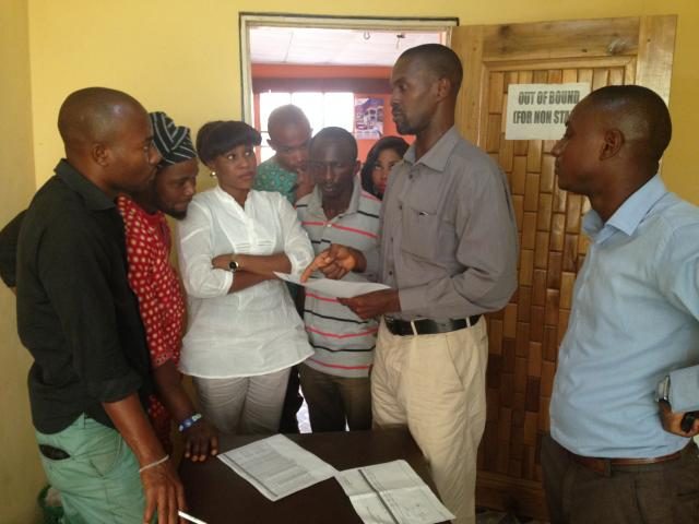 Oradian's Head of Implementation Onyeka Adibeli working with the staff of a Nigerian microfinance institution (MFI) to digitise and eliminate manual pen-and-paper processes