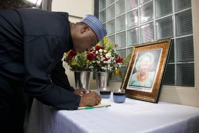 Senate President Bukola Saraki signing the Condolence Register for Ma Goldcoast Dickson