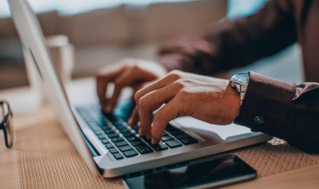 Man busy on his laptop commenting on news items