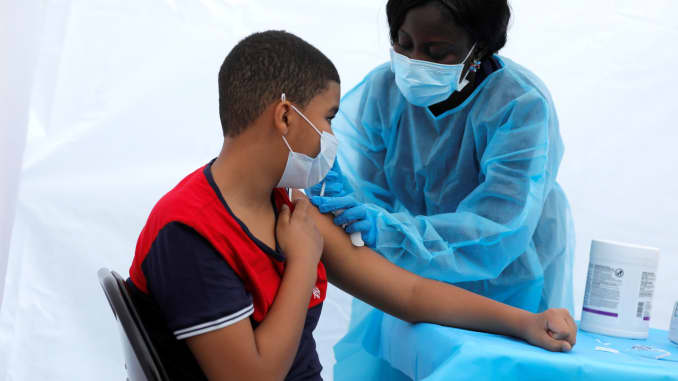 12-year-old Justing Concepcion receives a dose of the Pfizer-BioNTech vaccine for the coronavirus disease (COVID-19) from registered nurse Angela Nyarko, during a vaccination event for local adolescents and adults outside the Bronx Writing Academy school in the Bronx, New York City, June 4, 2021.