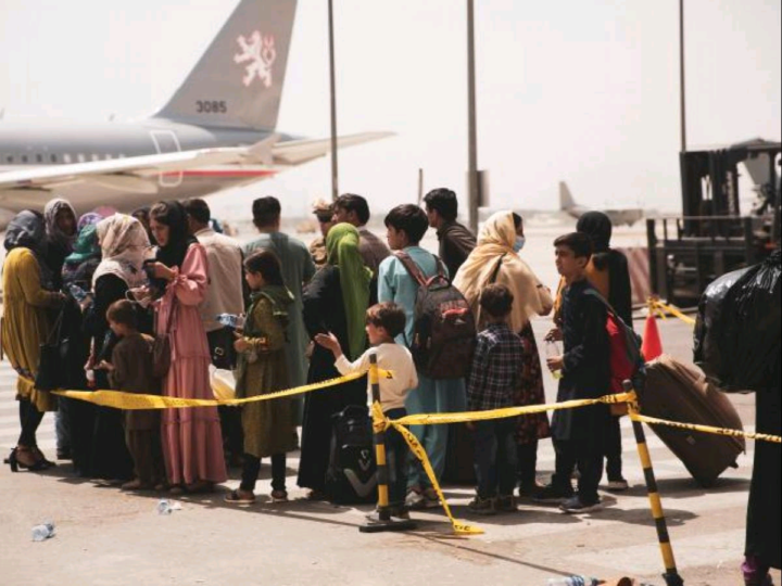 Civlians prepare to board a plane during an evacuation at Hamid Karzai International Airport, Kabul